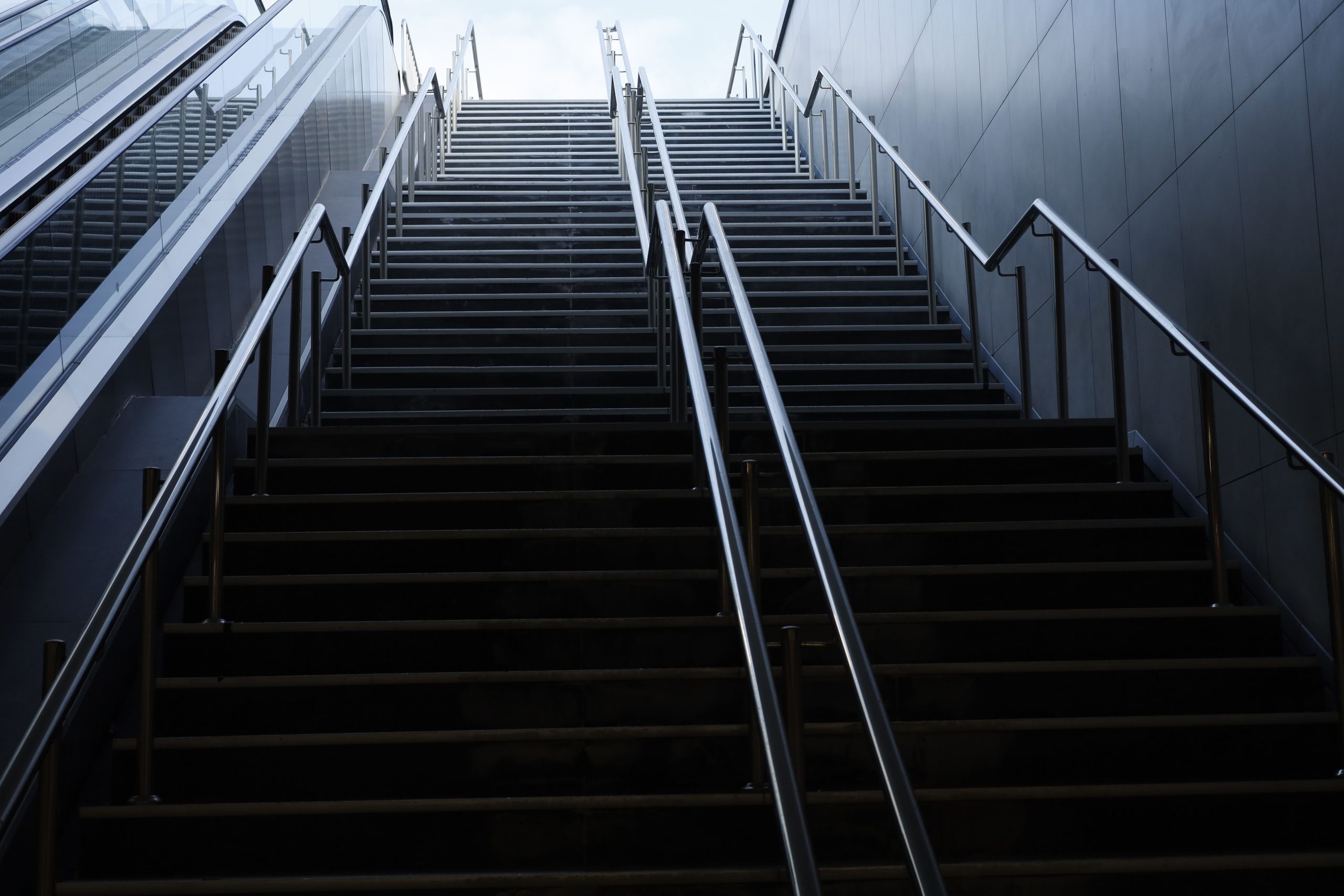 A dark urban staircase leading upwards, creating a dramatic visual effect.